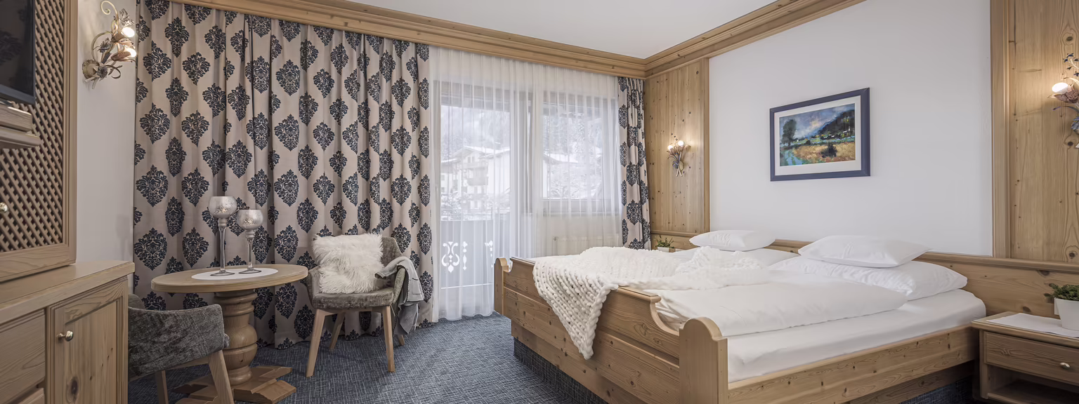 Gemütliches Ferienzimmer Nina im Platzlhof Ferienzimmer Nina im Hotel Platzlhof mit Doppelbett, kleiner Sitzecke und viel Tageslicht.