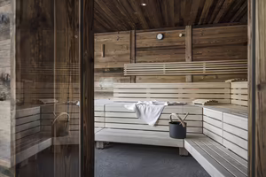 Gemütliche Holzsauna im Wellnessbereich des Hotel Platzlhof mit großzügigen Sitz- und Liegeflächen.